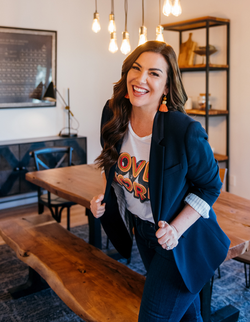 Amy porterfield smiling in navy blazer