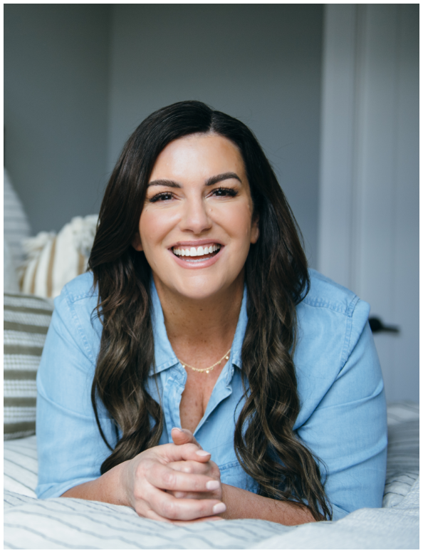 amy porterfield smiling at the camera wearing a blue shirt