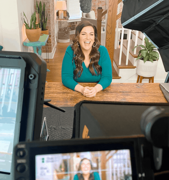 photo of amy porterfield recording course content with camera equipment