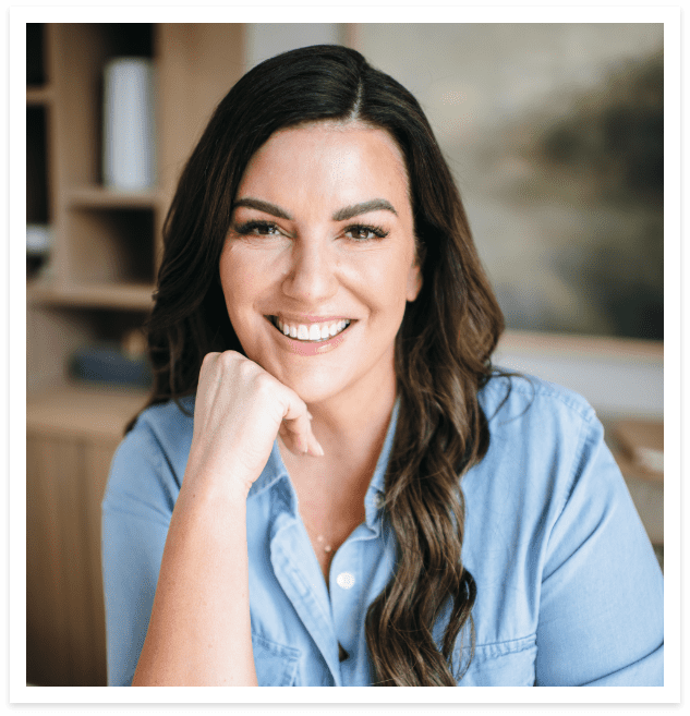 amy porterfield smiling at the camera wearing a blue shirt