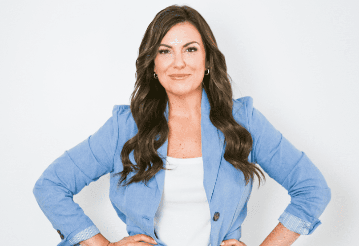amy porterfield smiling at the camera with her hands on her hips