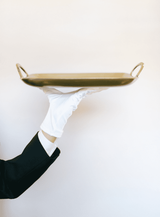 gloved hand holding platter