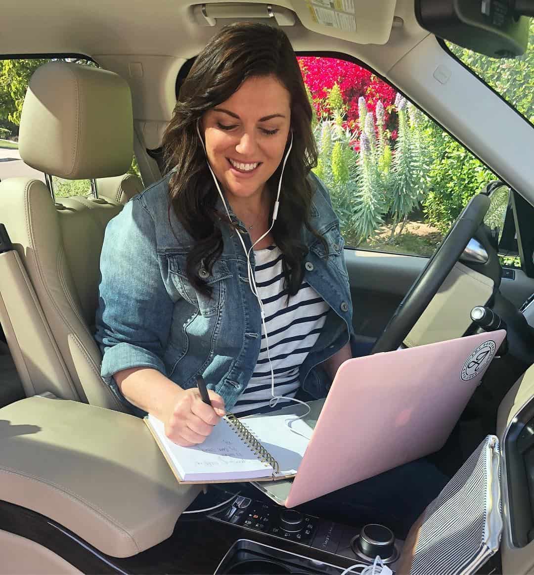 amy sitting in her car working on a launch