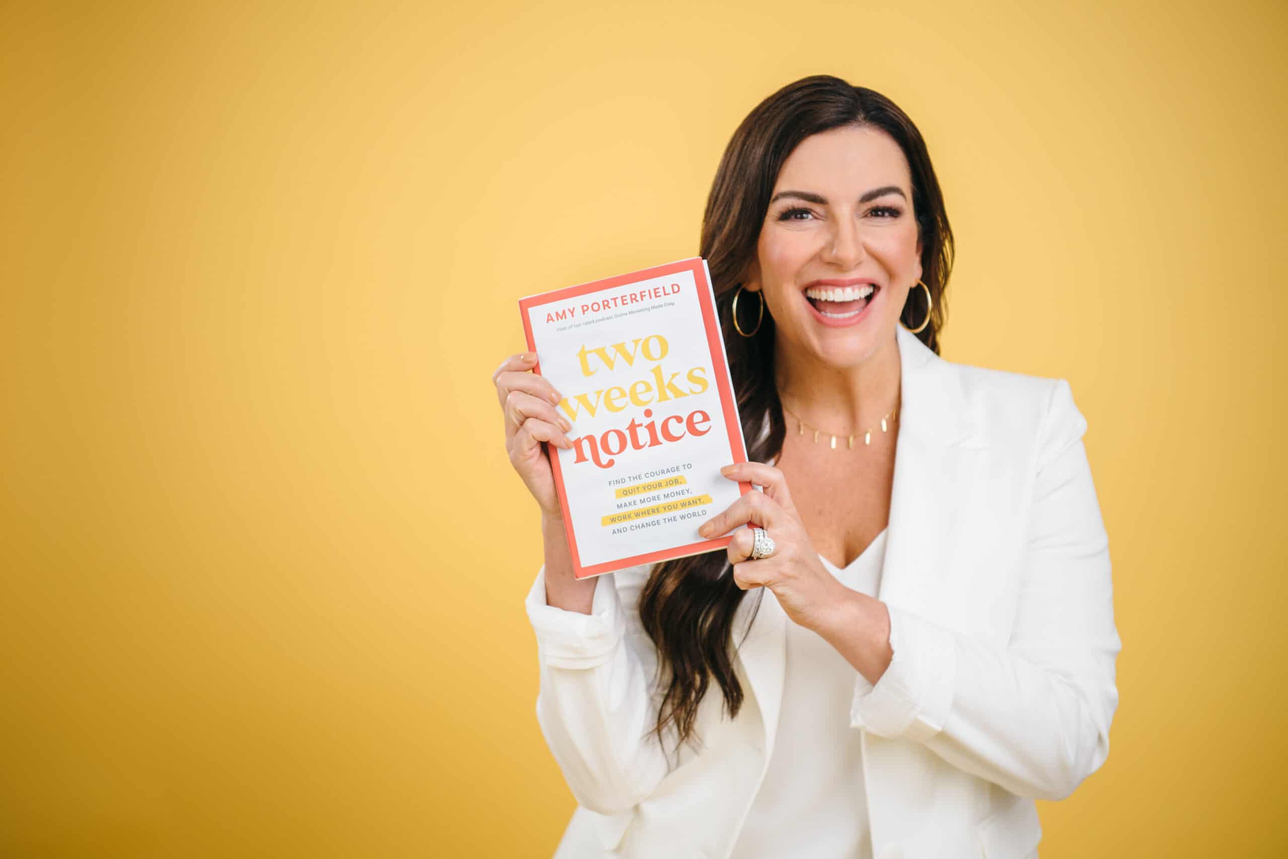 amy porterfield holding her book two weeks notice