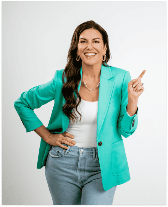 Amy Porterfield wearing green blazer and pointing