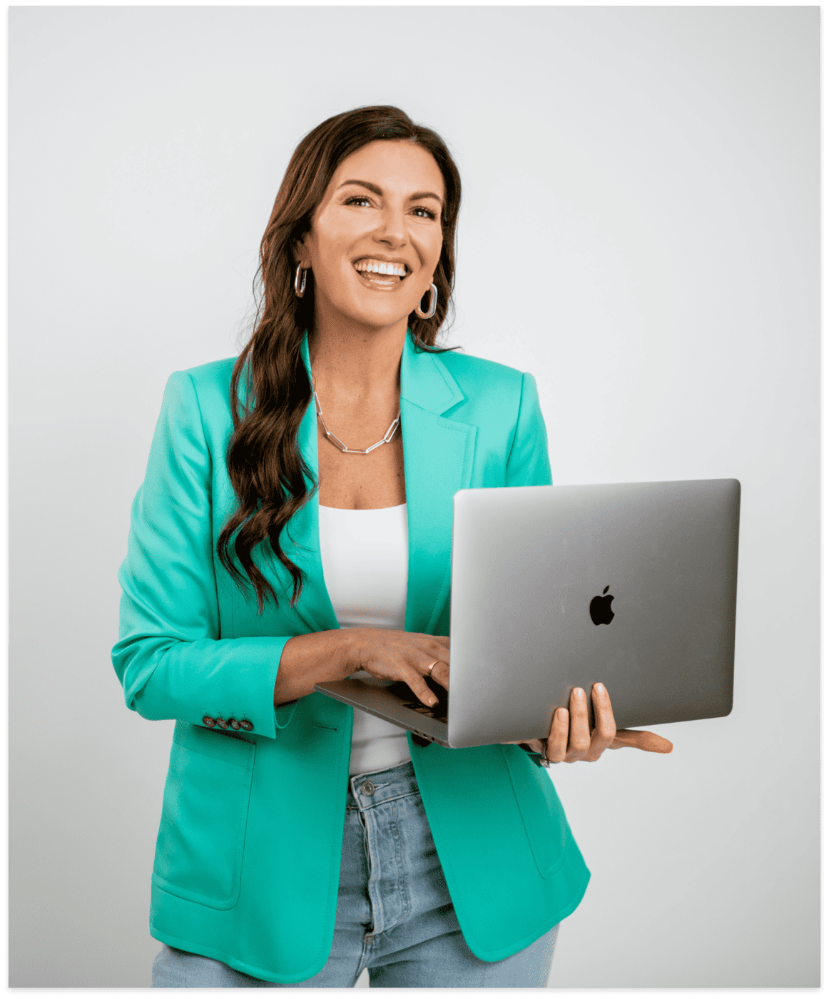 amy porterfield holding laptop wearing green blazer