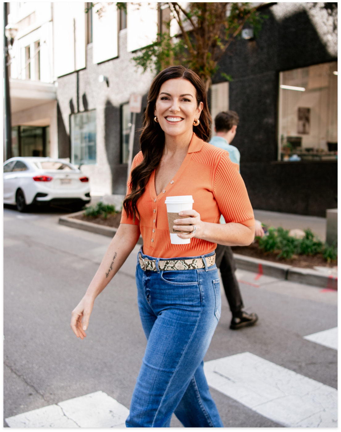 amy porterfield walking in the street with a cup of coffee